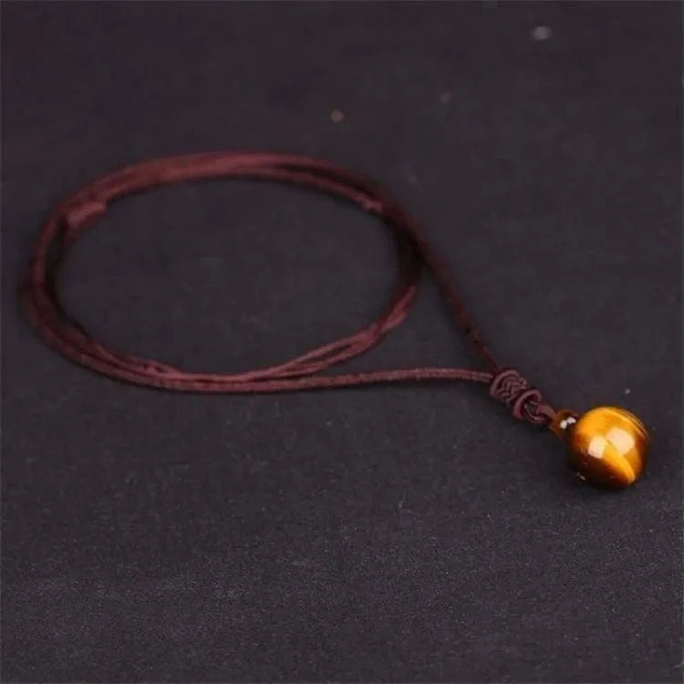Pendentif oeil de tigre cordon tressé