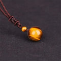 Pendentif oeil de tigre cordon tressé